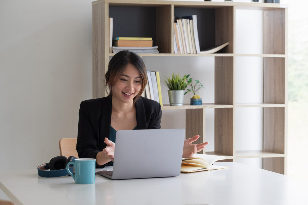 Beautiful business female resourceful person looking notebook table watching online training minded sit chair formalwear blazer modern office.