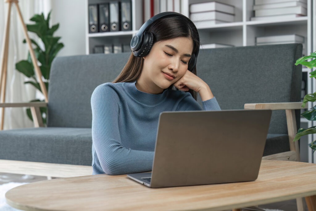 Woman, face and headphones for listening to music for calm, peace and mindfulness on home couch audio or motivation to relax or meditation above